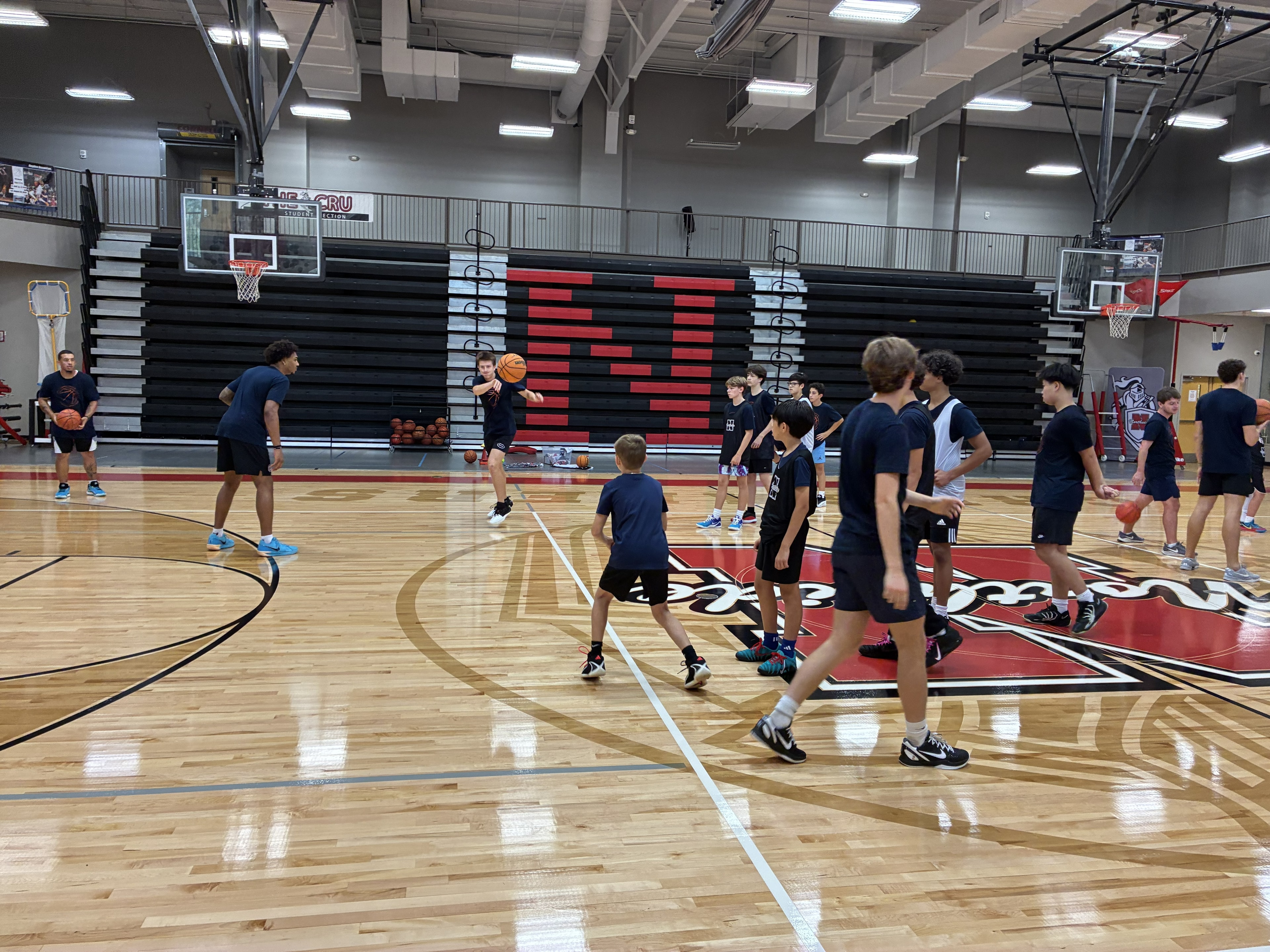 CBA4Youth campers listening during basketball training