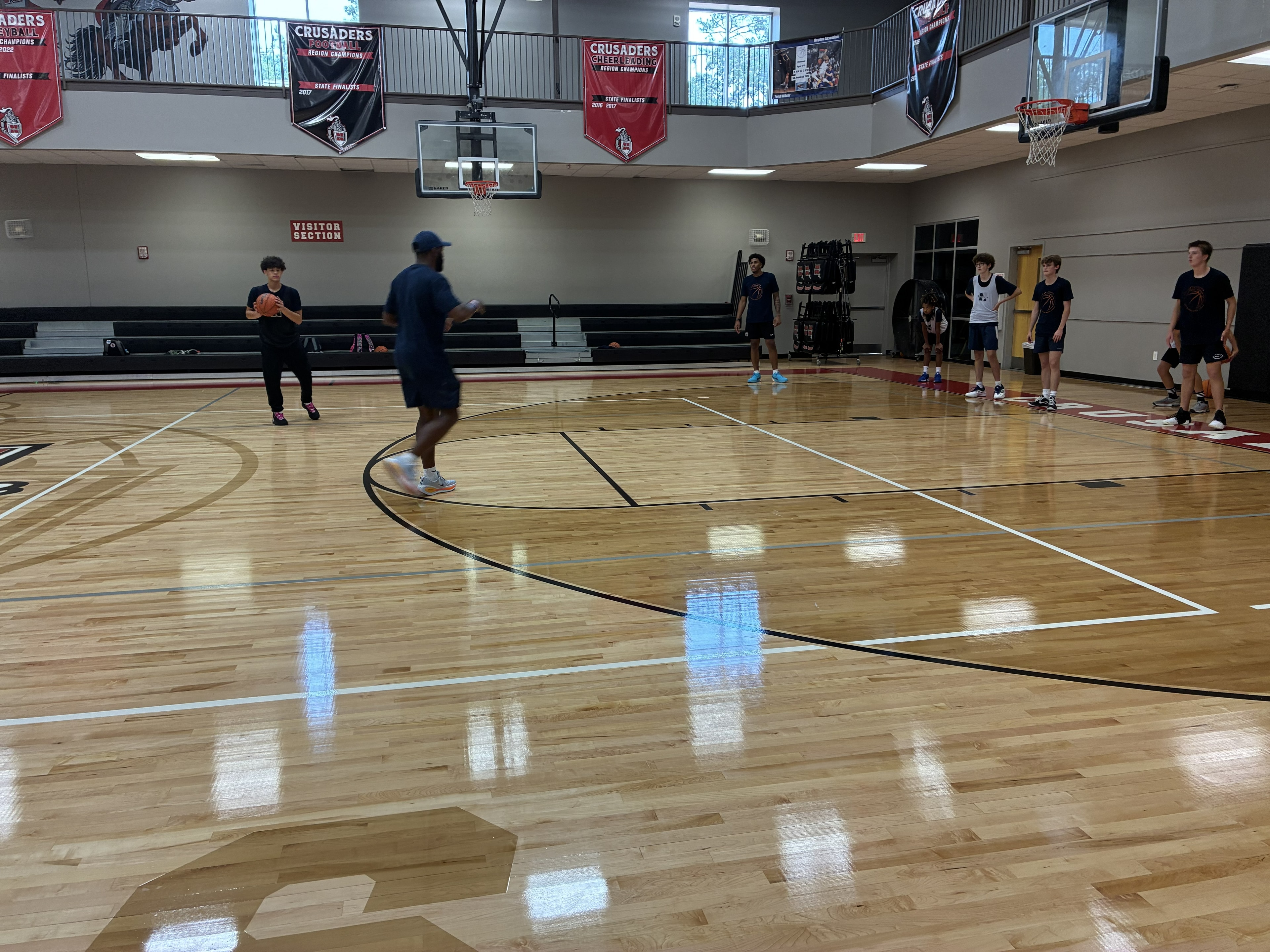 Coach guiding youth basketball players at camp