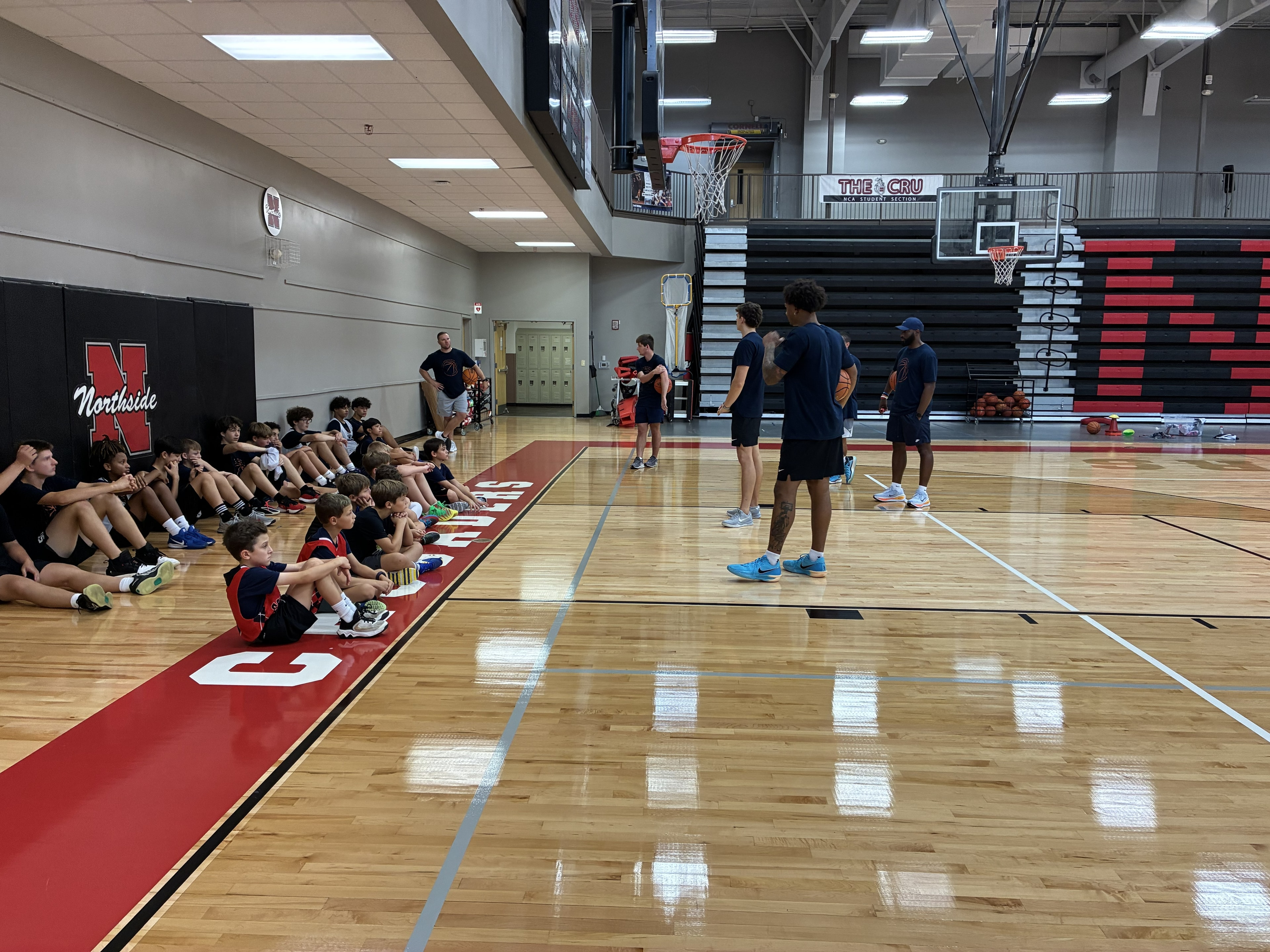 CBA4Youth campers listening to coaches during training